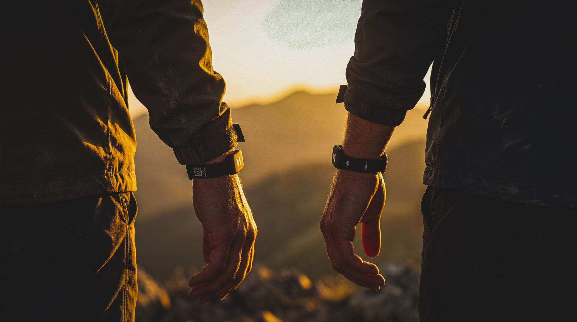 Hiker with NOMA Pulse wristband on mountain ridge